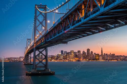 San Francisco skyline framed by the Bay Bridge at sunset
