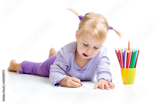 Cute kid drawing with color pencils photo