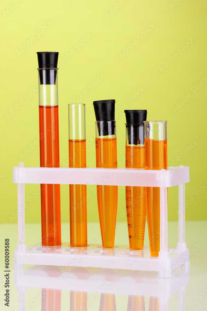 Test-tubes with a colorful solution on green background Test-tubes with a colorful solution on green background