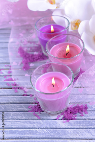 Beautiful colorful candles and  orchid flowers 