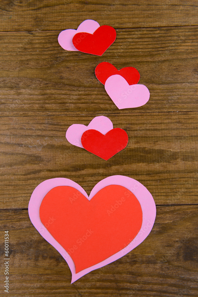 Paper hearts on wooden background Paper hearts on wooden background