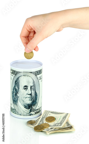 Female hand putting money in moneybox isolated on white