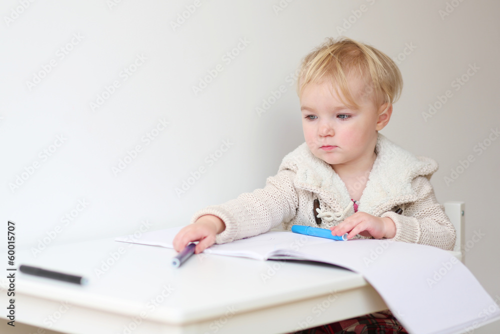 Happy blonde toddler girl drawing with colorful crayons Happy blonde toddler girl drawing with colorful crayons