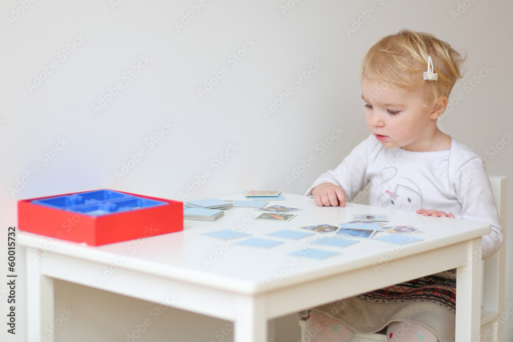 Adorable blonde toddler girl playing memory game Adorable blonde toddler girl playing memory game
