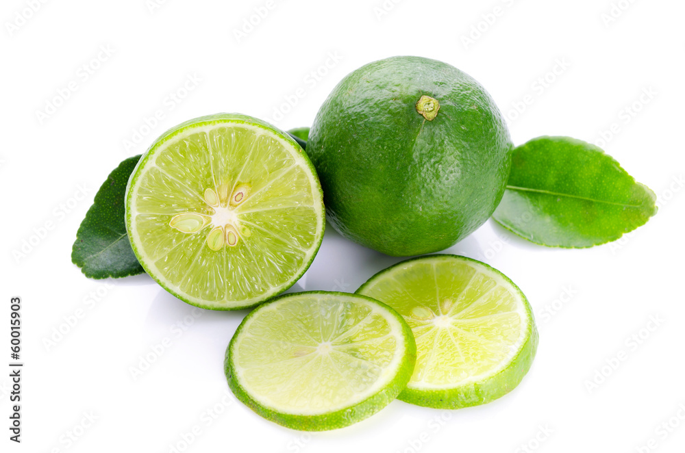 Limes with lime slices and leaves isolated on white background