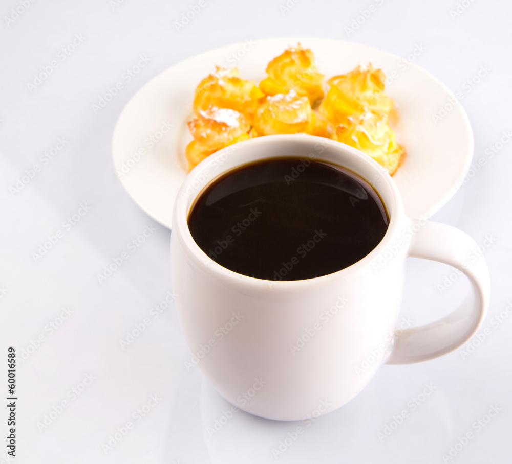 Homemade cream puff and a mug of coffee Homemade cream puff and a mug of coffee