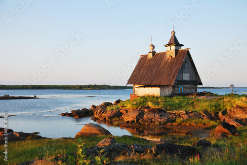 Old wooden church on sunset near White Sea, Russia North