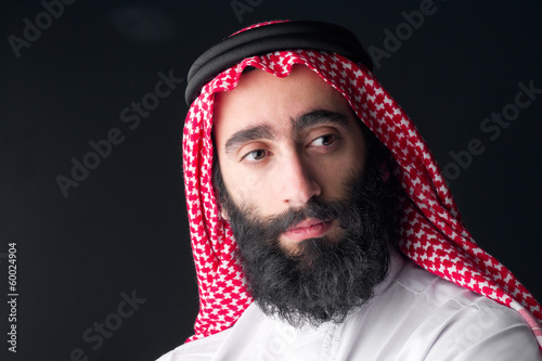 Portrait of a handsome young arabian man with a bushy beard photo