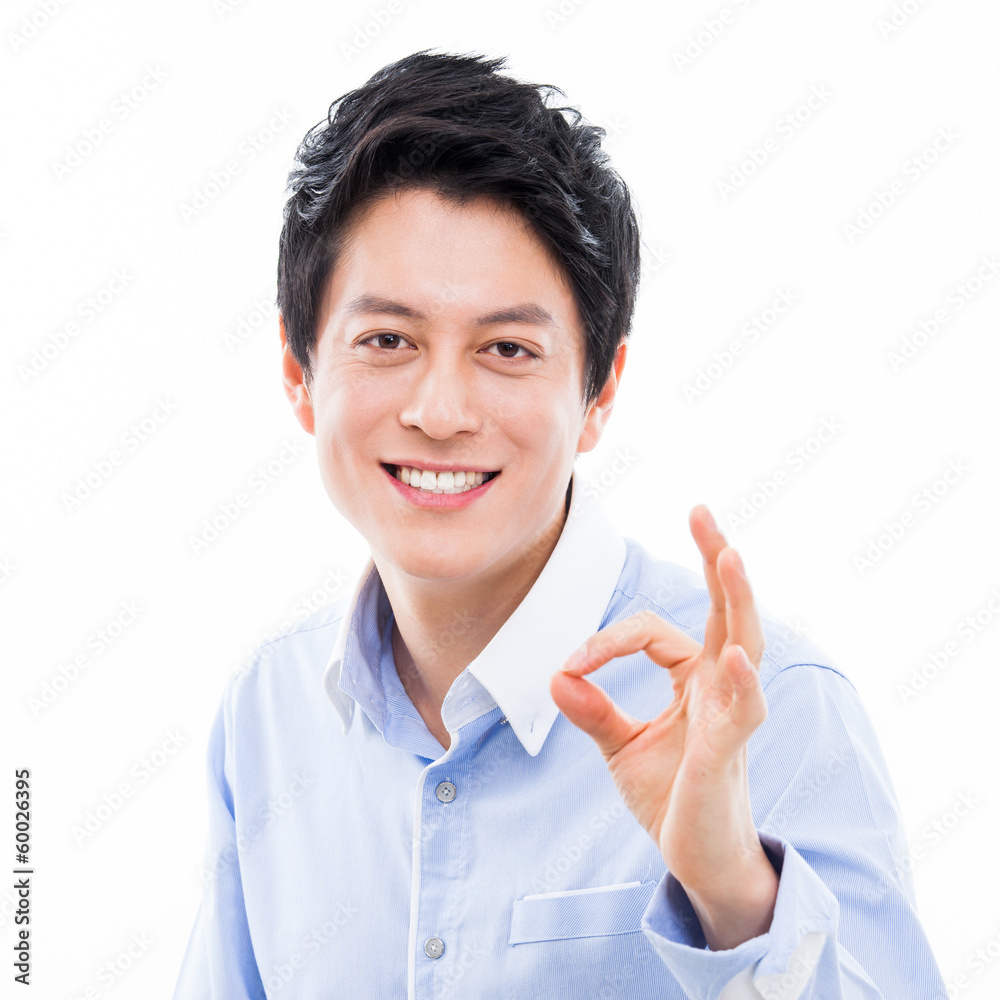 Young asian man showing okay sign. Young asian man showing okay sign.