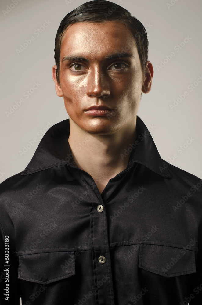 Sexy man wearing make up, dressed in a black shirt Sexy man wearing make up, dressed in a black shirt