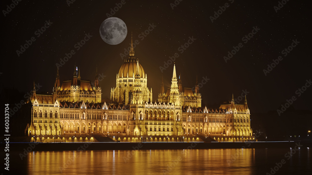 Parliament of Budapest, Hungary at night by the full moon