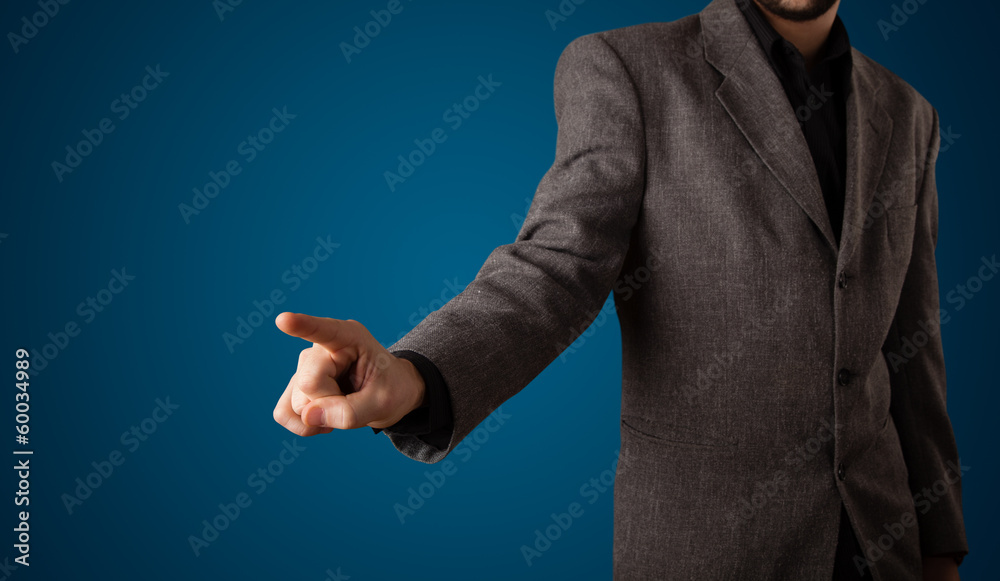 Fototapeta premium Businessman pressing imaginary button