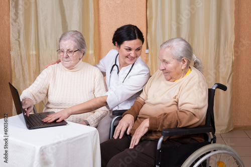 couple of senior Woman with carer Learning Computer Together