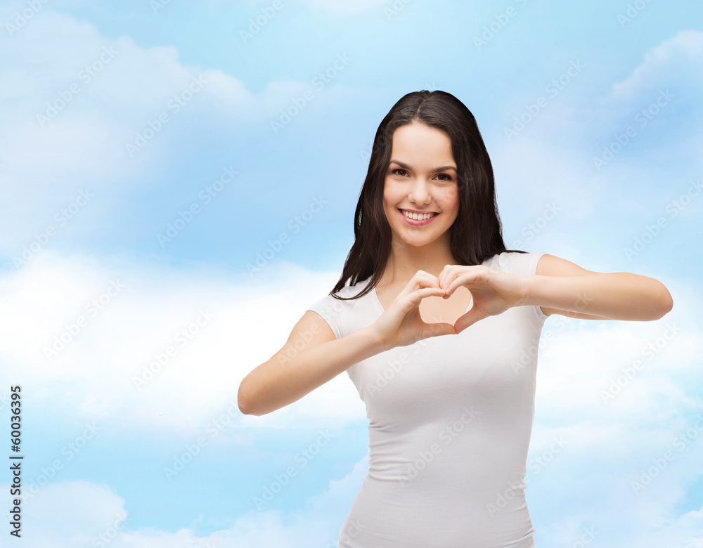 smiling girl showing heart with hands smiling girl showing heart with hands