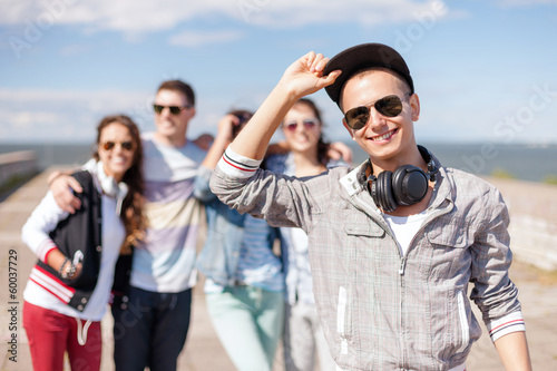 teenage boy with sunglasses and friends outside