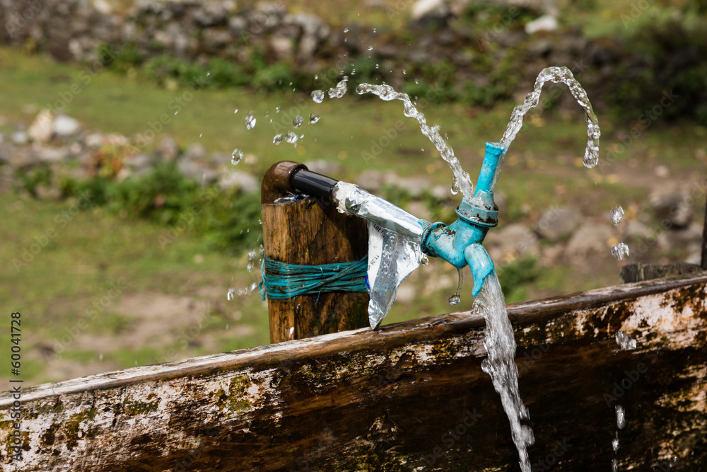 Naklejka premium Leaking Tap at a Drinking Trough, Himalaya, Nepal