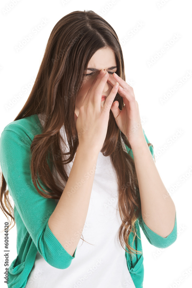 Young beautiful woman with sinus pressure, touching her nose. Young beautiful woman with sinus pressure, touching her nose.