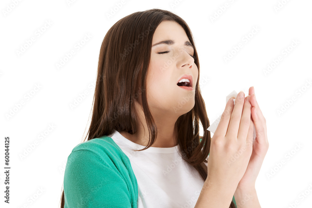 Young beautiful woman is sneezing. Young beautiful woman is sneezing.