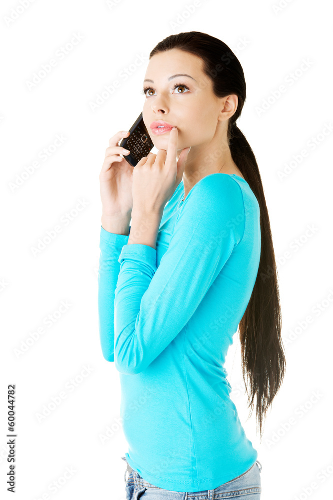 Young beautiful woman talking through phone. Young beautiful woman talking through phone.
