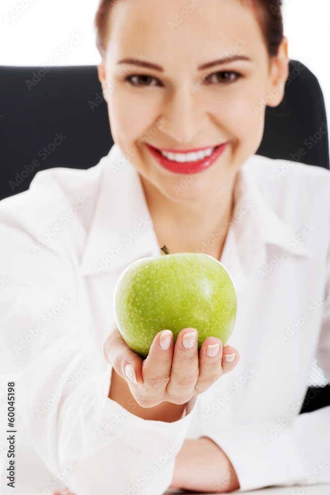 Young beautiful business woman holding an apple. Young beautiful business woman holding an apple.