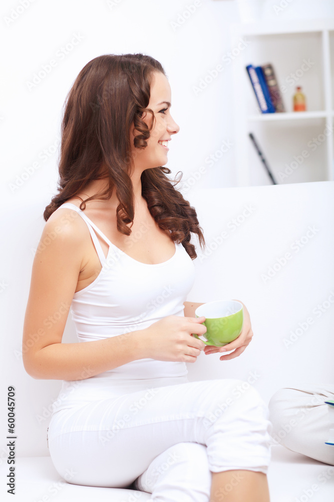 Young pretty woman in white at home Young pretty woman in white at home