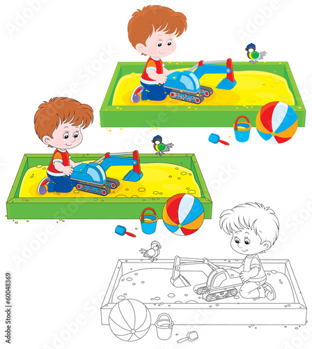 boy playing with a toy excavator in a sandbox