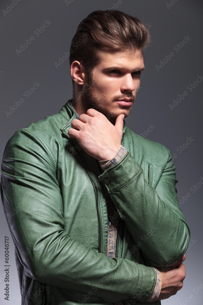 pensive fashion man in leather jacket looking away