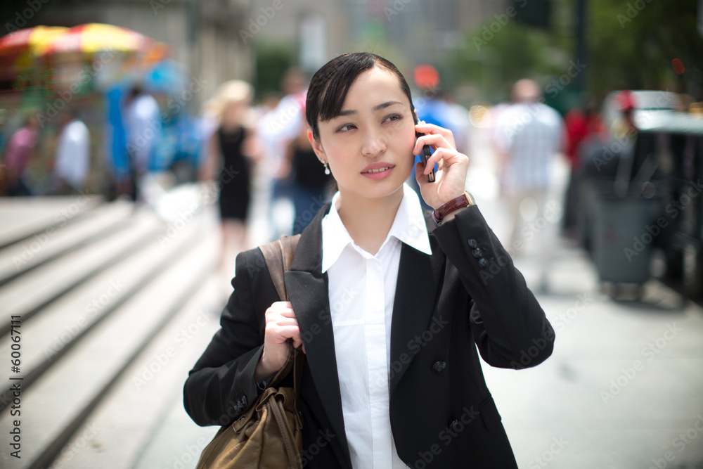 Asian business woman in New York City on cellphone Asian business woman in New York City on cellphone