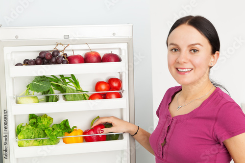 Young woman looking into a refrigerator