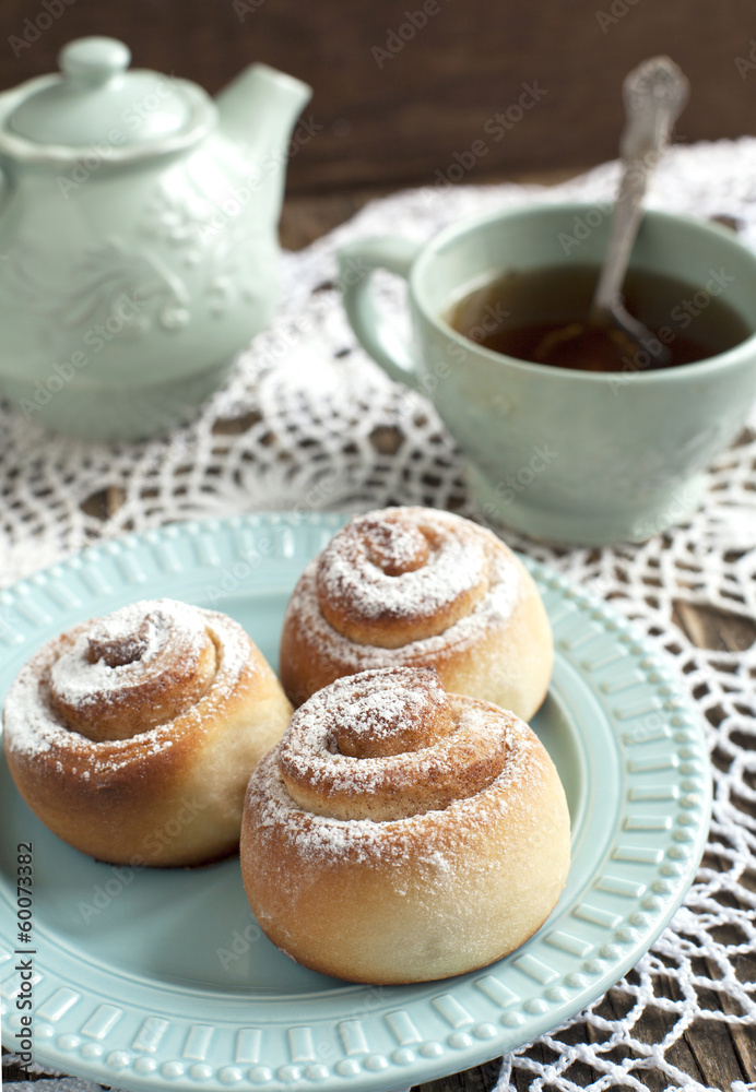 Fresh Sweet Homemade Cinnamon Rolls and Cup of Tea Fresh Sweet Homemade Cinnamon Rolls and Cup of Tea