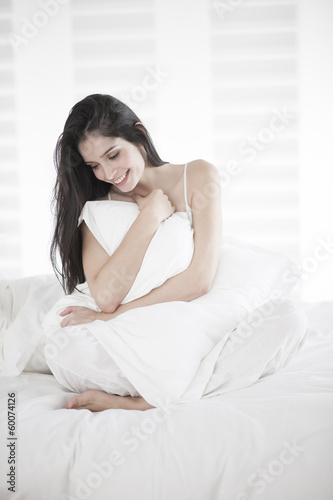 Beautiful woman on a bed © jackfrog