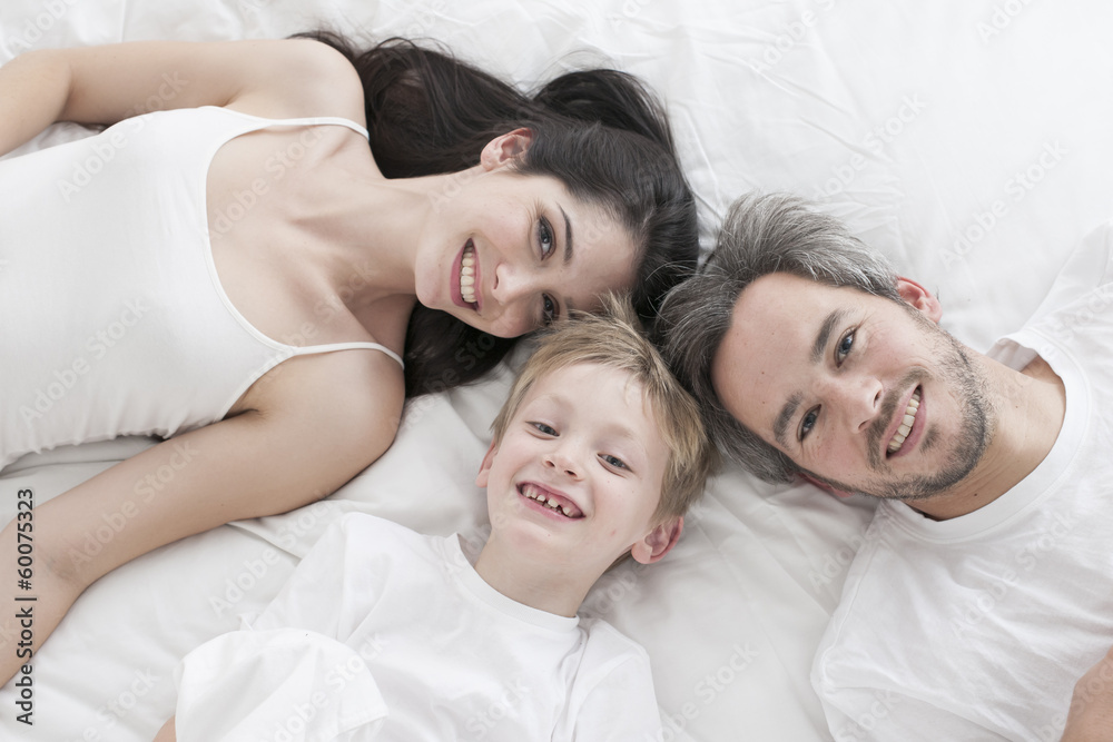 Lovely family lying in bed