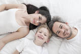 Lovely family lying in bed