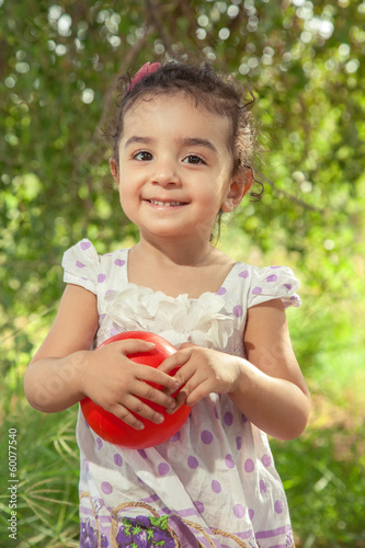 Beautiful small girl is holding her ball