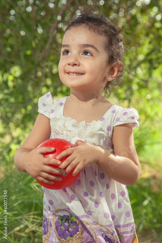 Beautiful small girl is holding her ball