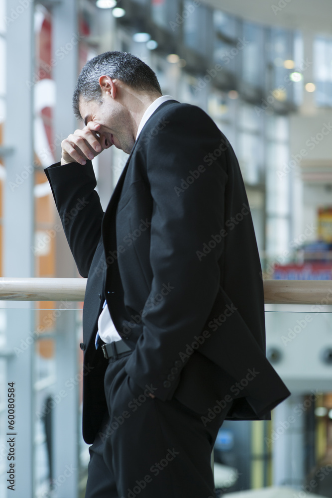 Businessman smirking and covering eyes Businessman smirking and covering eyes