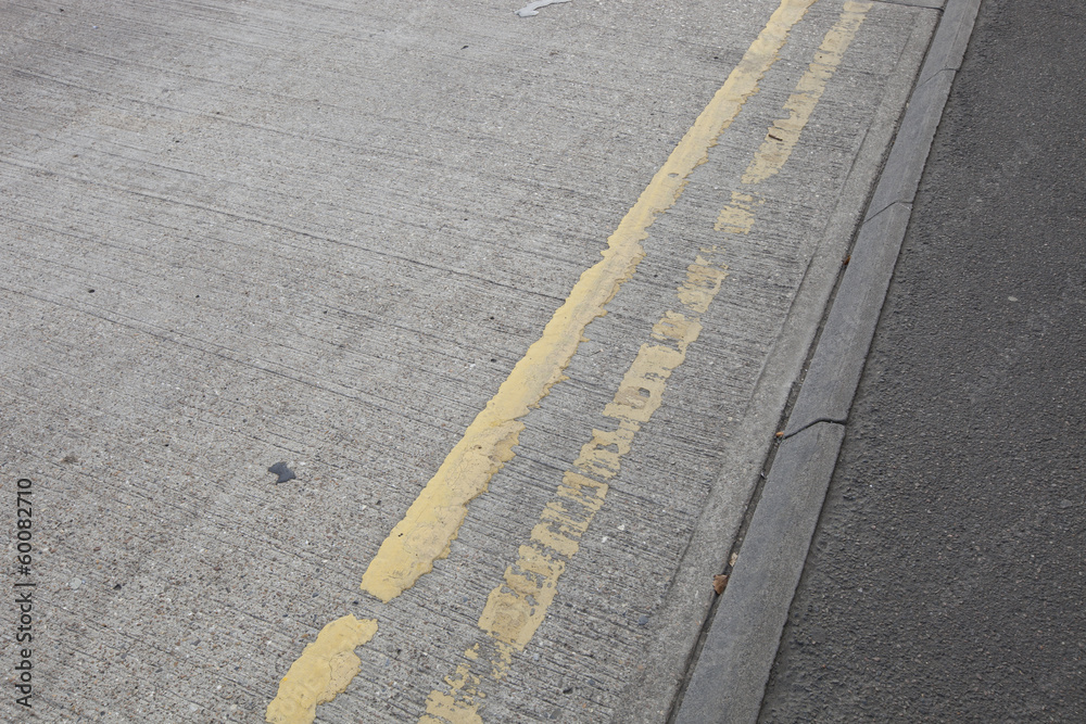 Close-Up of double yellow line on road Close-Up of double yellow line on road