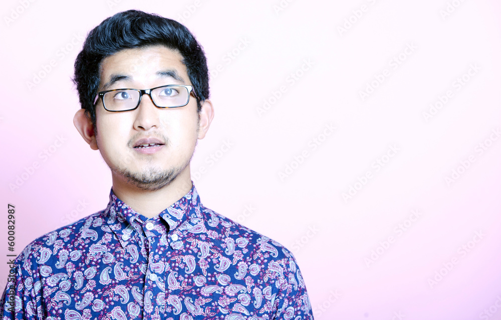 Fototapeta premium Young Geeky Asian Man in colorful shirt wearing glasses