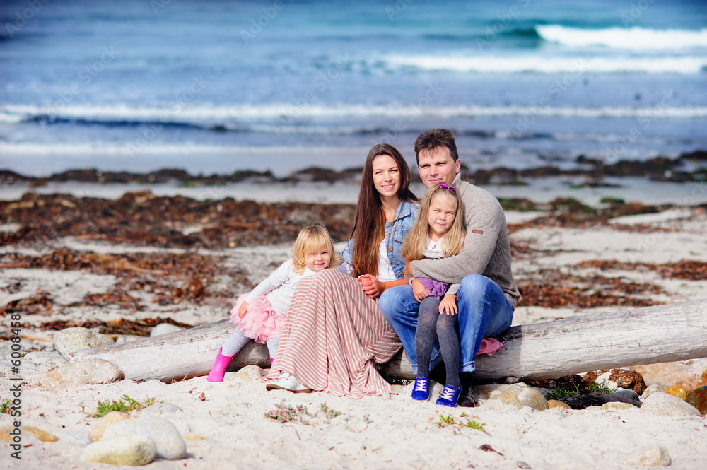 portrait happy young family in casual fashion wear on a sandy be portrait happy young family in casual fashion wear on a sandy be