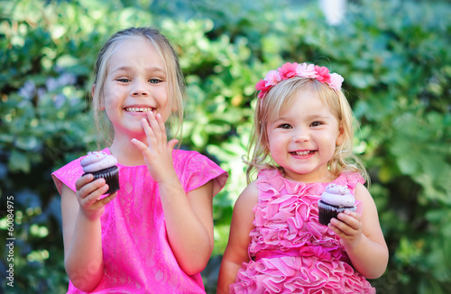 group of two cute fashion little girls eat happy birthday pink c
