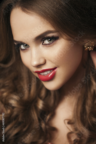 Fototapeta Naklejka Na Ścianę i Meble -  Portrait of beautiful girl with red lips, red manicure. Close up