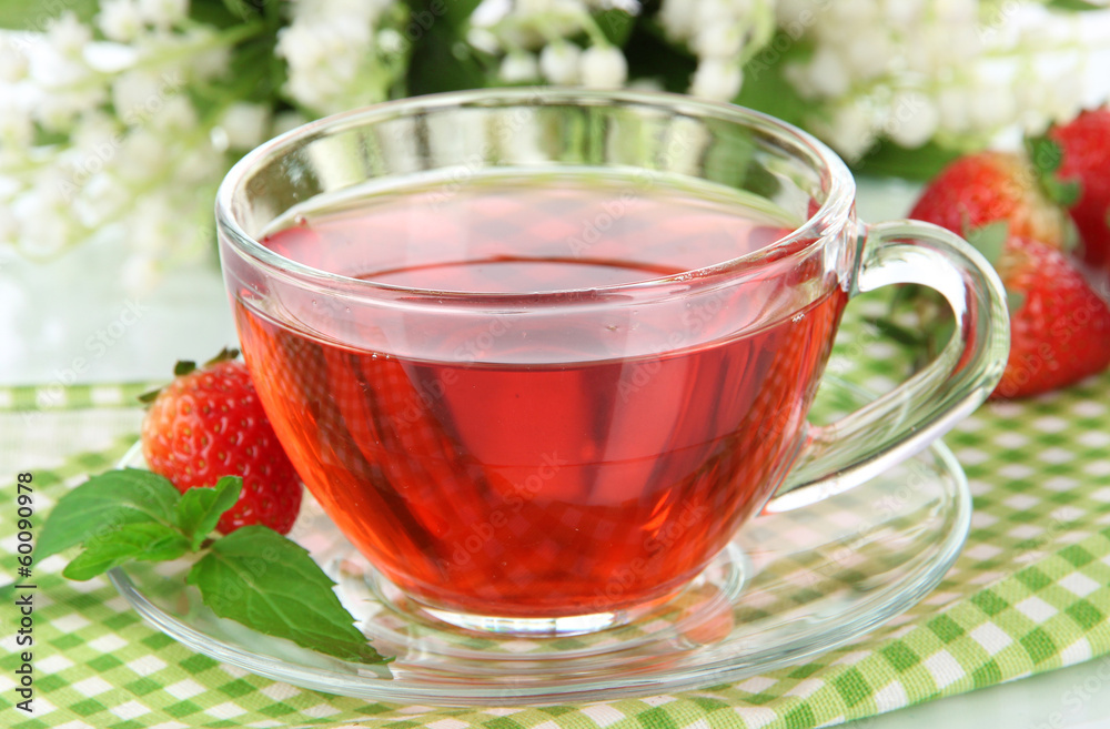 Delicious strawberry tea on table close-up Delicious strawberry tea on table close-up