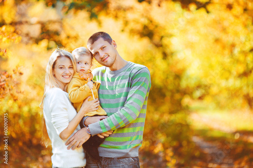 happy family having fun outdoors in autumn in the park