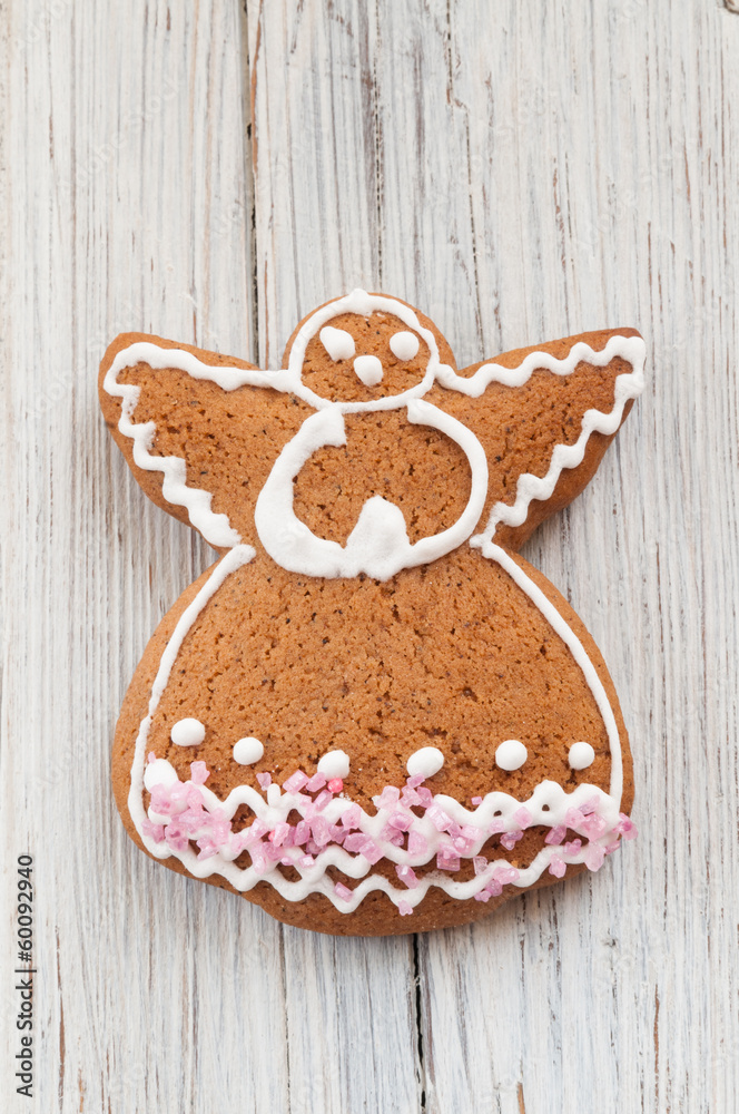 Christmas gingerbread angel on wooden background Christmas gingerbread angel on wooden background