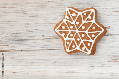Christmas gingerbread star on wooden background