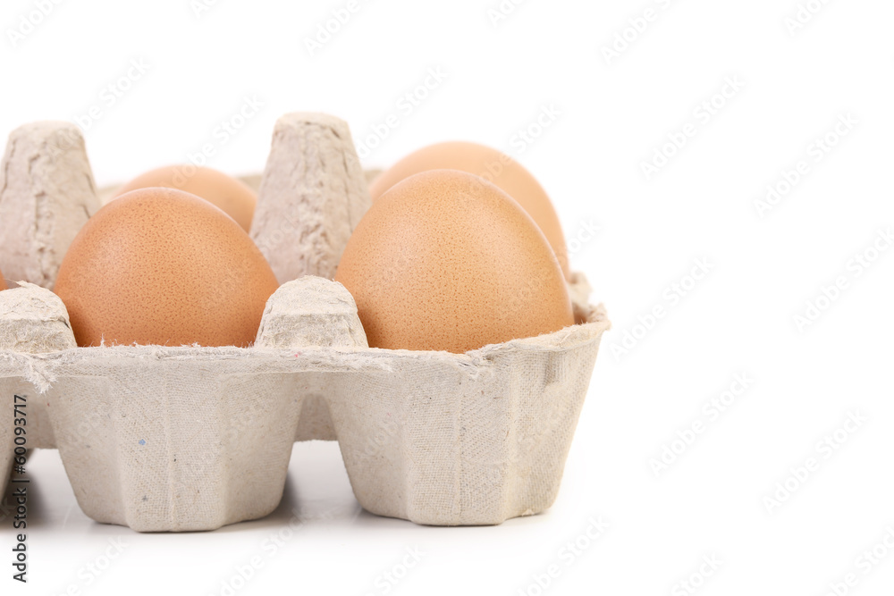 Brown eggs in egg box.