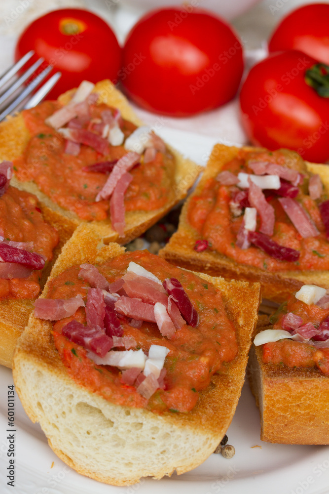 bread with tomatoes and jamon close up bread with tomatoes and jamon close up