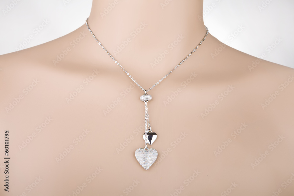 Silver necklace with two heart pendants on a mannequin Silver necklace with two heart pendants on a mannequin
