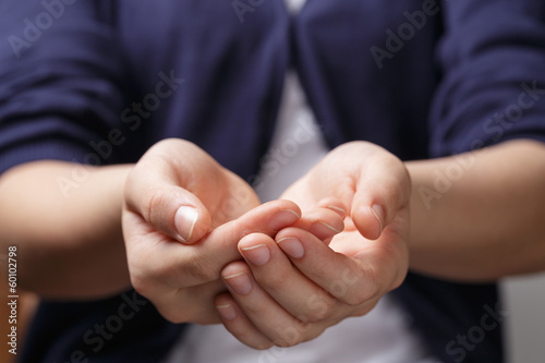 female teen cupped hands showing something