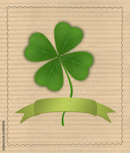 Clover with four leaves on cardboard